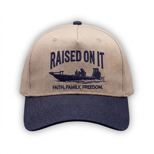 Outboard Legacy Hat in Skiff (navy brim, navy stitch) with embroidered Raised On It skiff logo and Faith Family Freedom