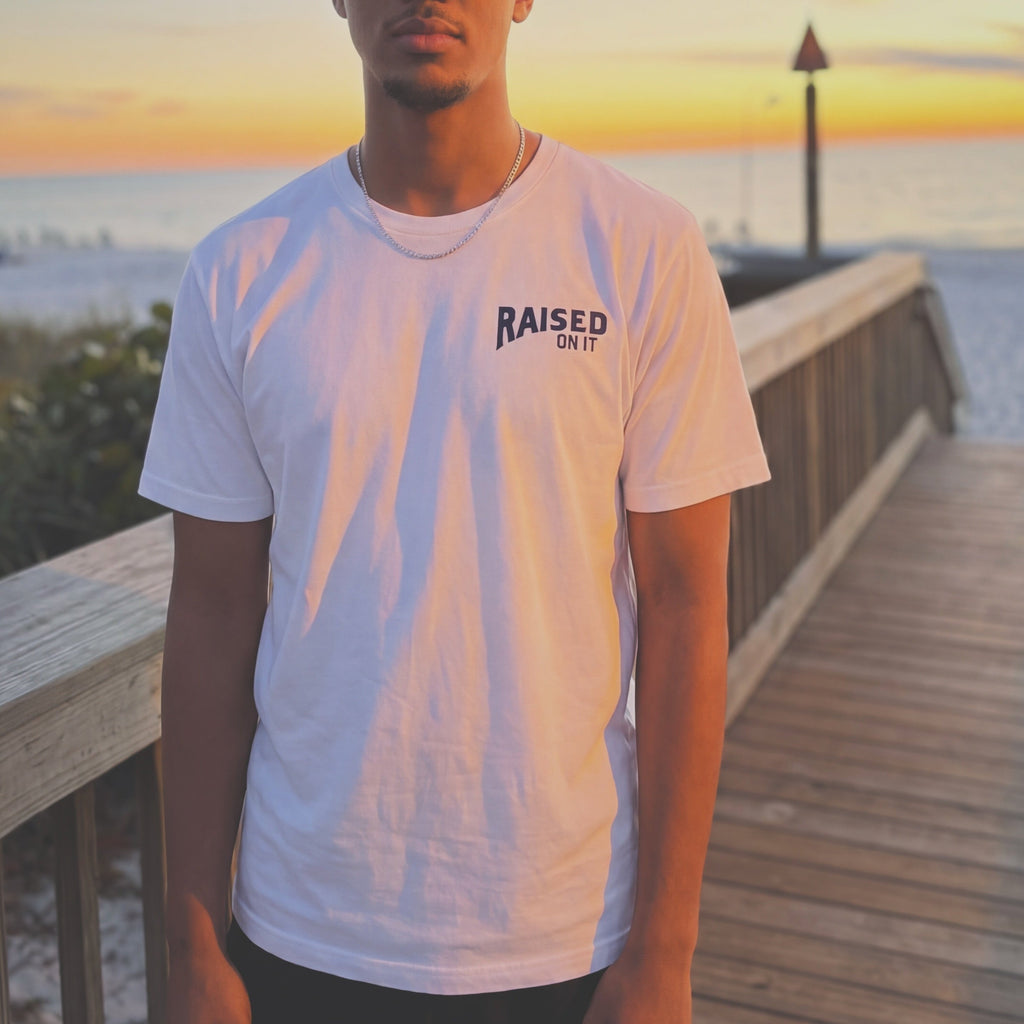 Front of the Florida Cowboy tee worn on a Florida beach boardwalk at sunset