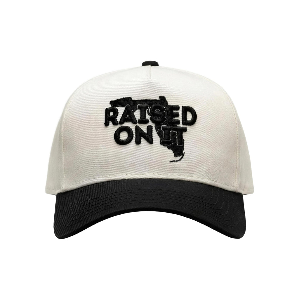 Raised On It Florida Logo embroidered trucker hat in White/Black, canvas white crown, black bill, black Florida logo stitch
