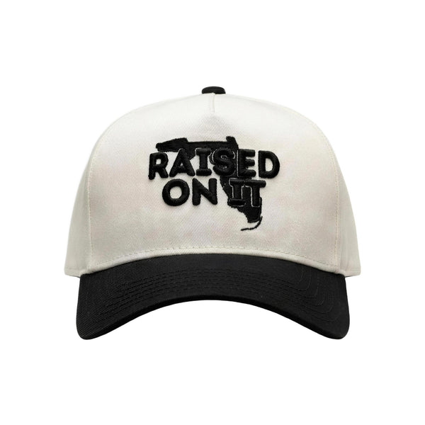 Raised On It Florida Logo embroidered trucker hat in White/Black, canvas white crown, black bill, black Florida logo stitch